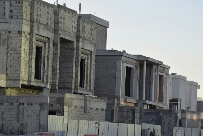 Row of houses under construction against sky